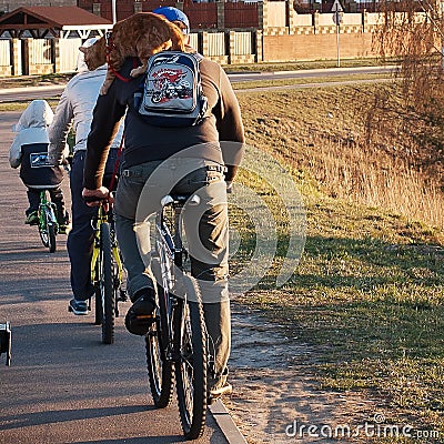 Family ride bikes with cat Editorial Stock Photo